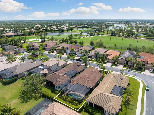 an aerial view of a house with outdoor space and lake view in back