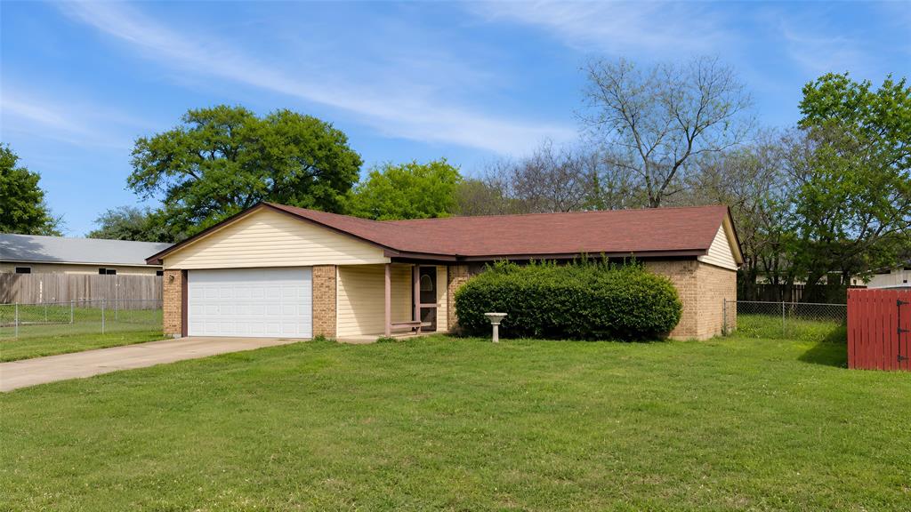 Single-story residence featuring a brick and siding exterior, a two-car garage, and a brown shingle roof