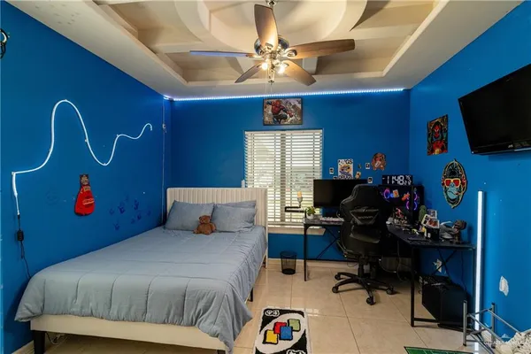 a bedroom with a bed and a tv