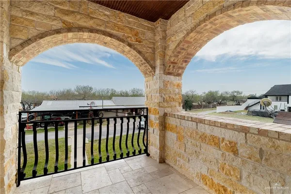 a balcony with view of trees in front