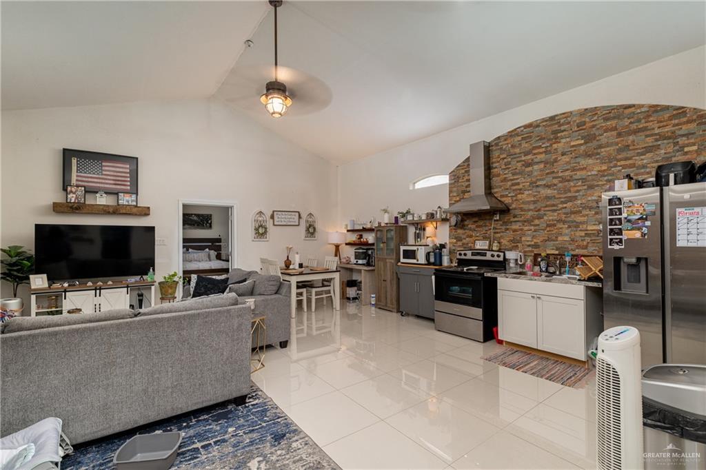 5048 Mile 8 Road Edinburg, TX 78541 - Photo 20 of 33 a living room with stainless steel appliances kitchen island granite countertop furniture and a fireplace