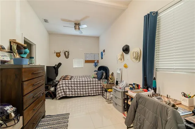 a bedroom with furniture and a window