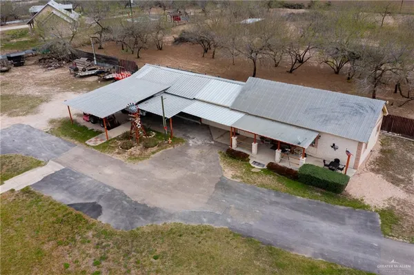 an aerial view of a house with a yard and lake view