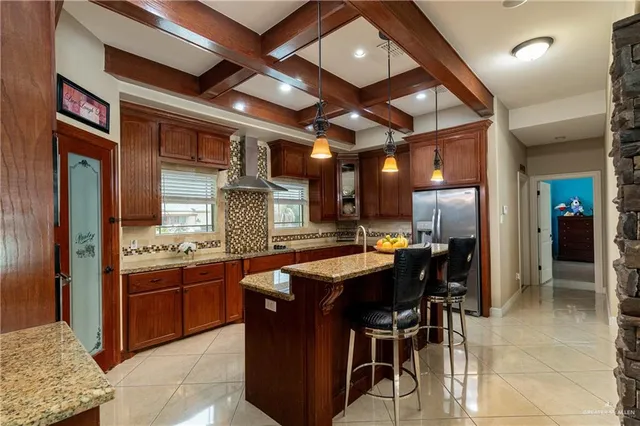 a kitchen with stainless steel appliances granite countertop a stove and a refrigerator