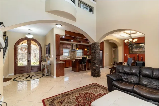 a living room with furniture and a large mirror