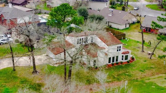 an aerial view of a house with a yard
