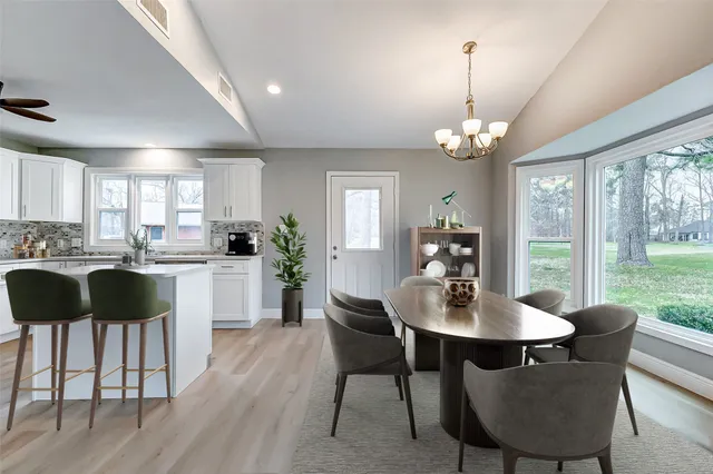 a kitchen with cabinets stainless steel appliances and a window