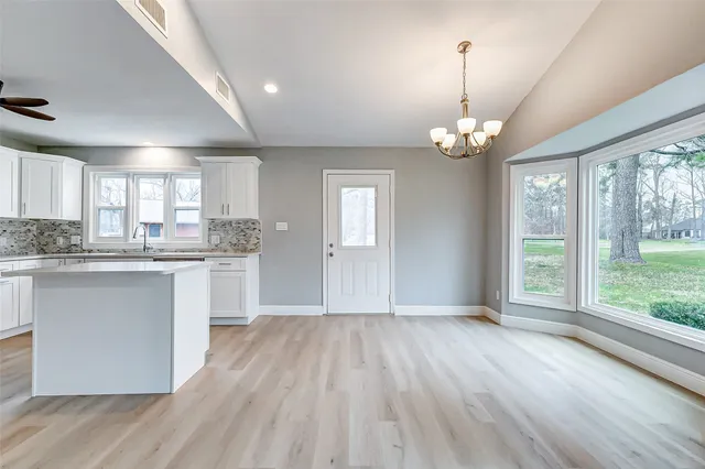 a bedroom with furniture and a flat screen tv