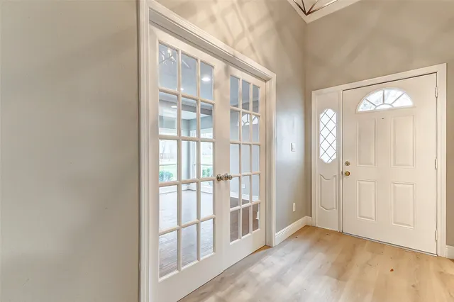 a view of an entryway with wooden floor