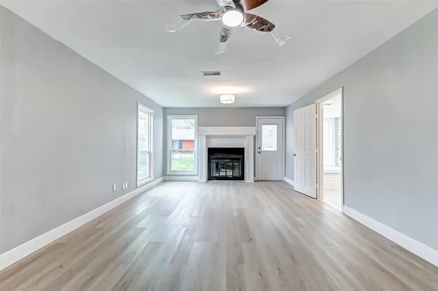 a view of a hallway with wooden floor and entryway