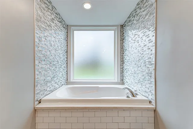 a bathroom with a sink toilet vanity and tub