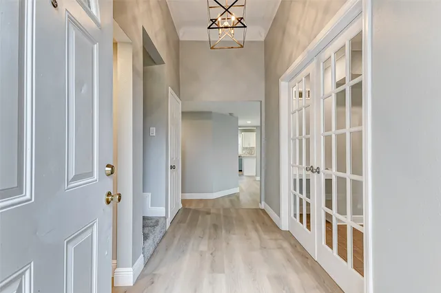 a view of a hallway with wooden floor and staircase