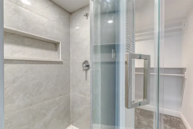 an empty room with fan and windows