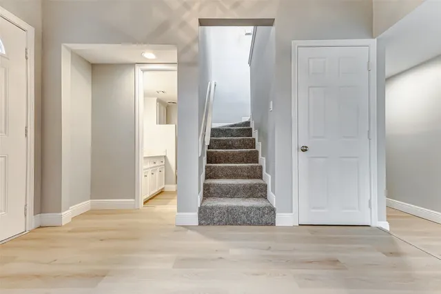 a view of an empty room with a ceiling fan and window