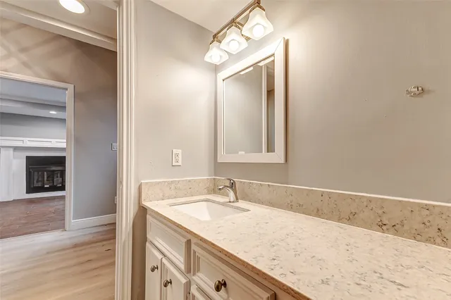 a view of a room with wooden floor and cabinets