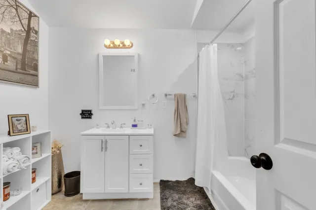 a bathroom with a sink a mirror and shower