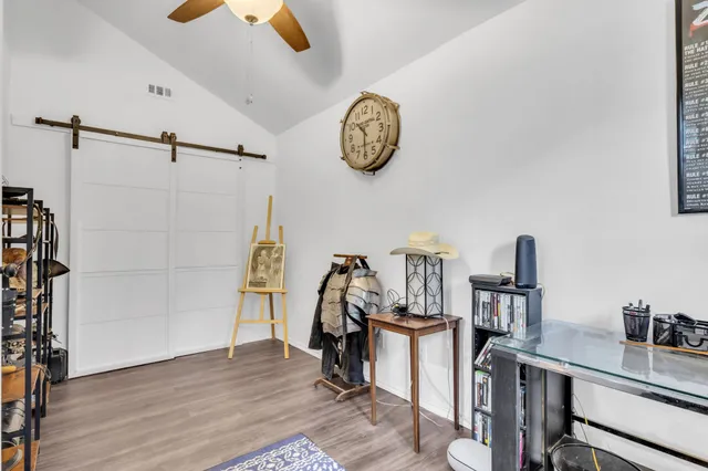 a view of a workspace with furniture and a window