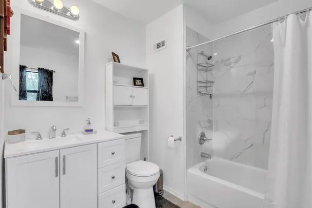 a bathroom with a sink toilet a shower and a mirror