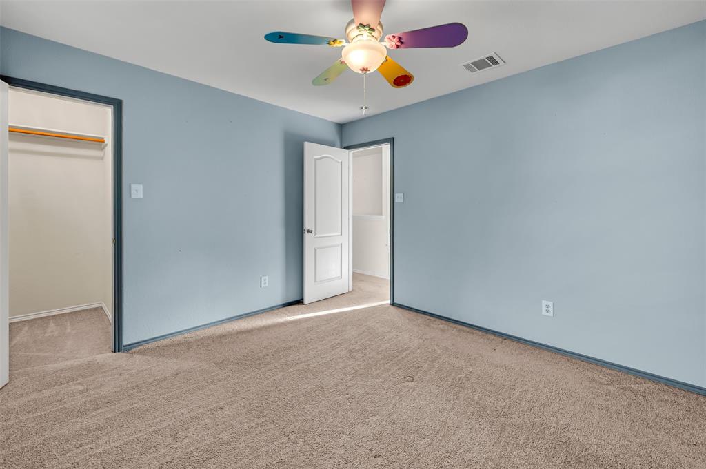 9017 Graywolf Ridge Trail Fort Worth, TX 76244 - Photo 19 of 27 Unfurnished bedroom featuring light carpet, a closet, and ceiling fan