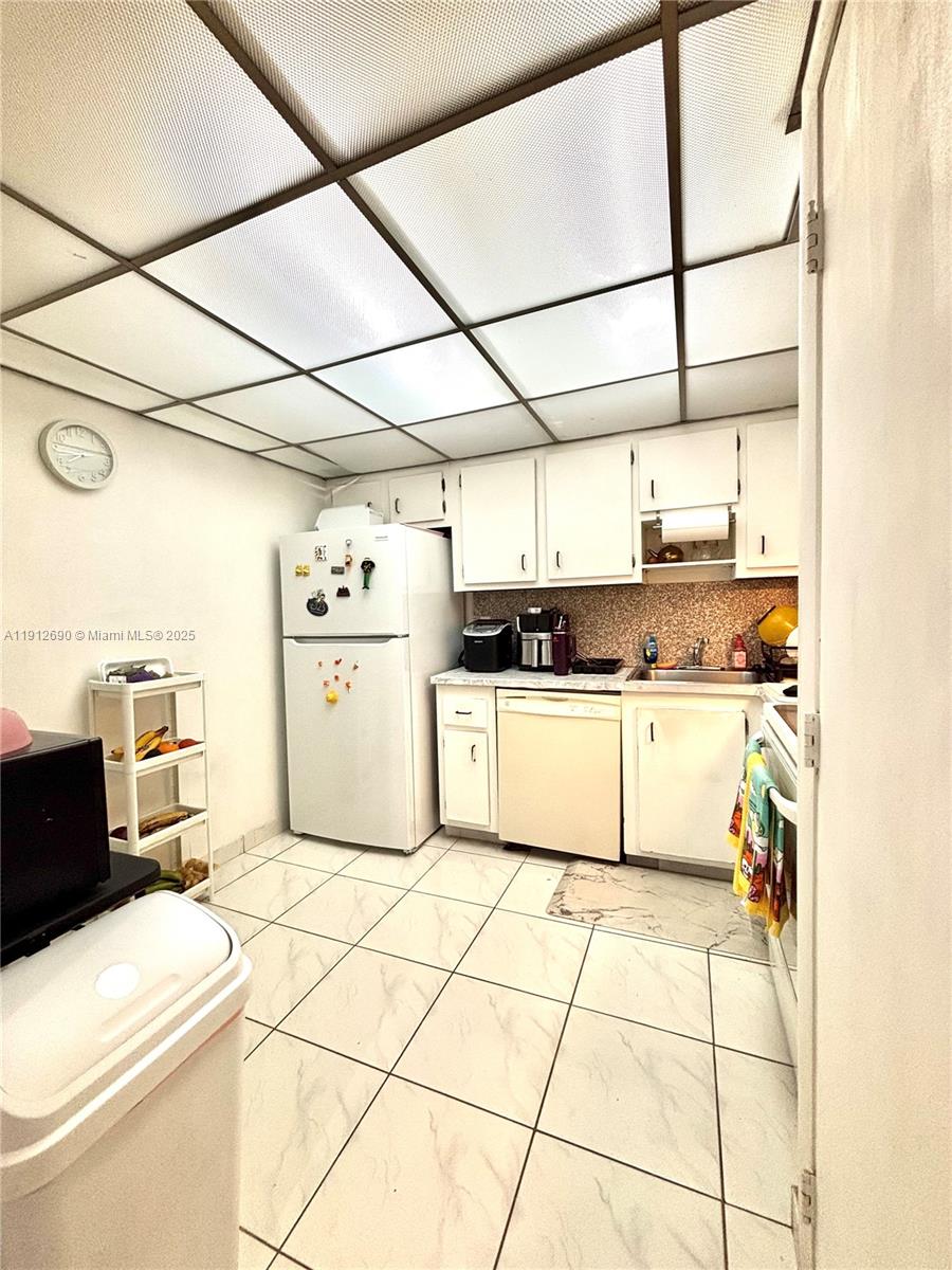4160 Inverrary Drive, Unit 204 Lauderhill, FL 33319 - Photo 3 of 9 a kitchen with stainless steel appliances a stove a sink and white cabinets