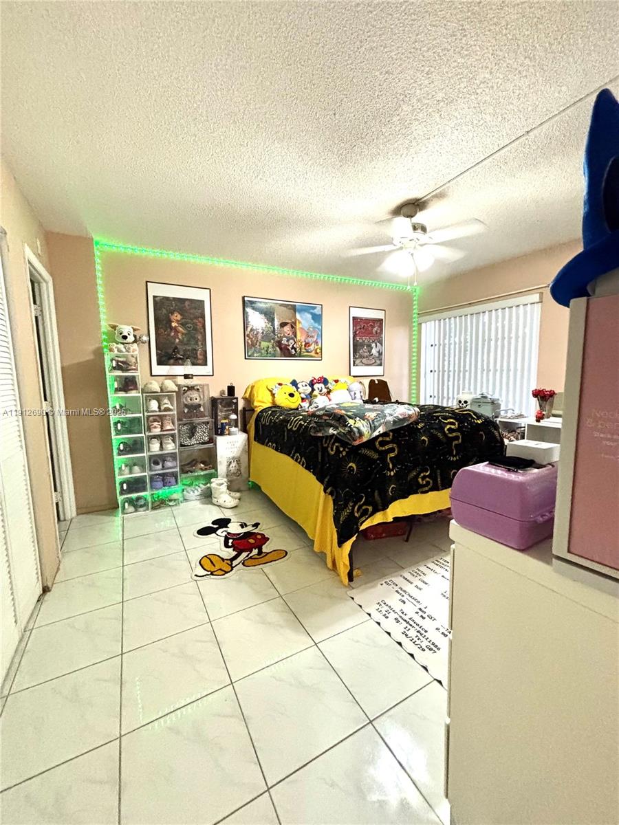 4160 Inverrary Drive, Unit 204 Lauderhill, FL 33319 - Photo 6 of 9 a bedroom with a bed and a couch