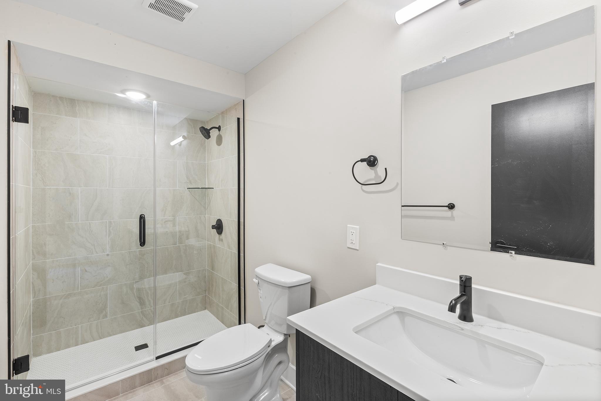 1903 Jackson Street, Unit 1 Philadelphia, PA 19145 - Photo 11 of 17 a bathroom with a sink toilet and shower