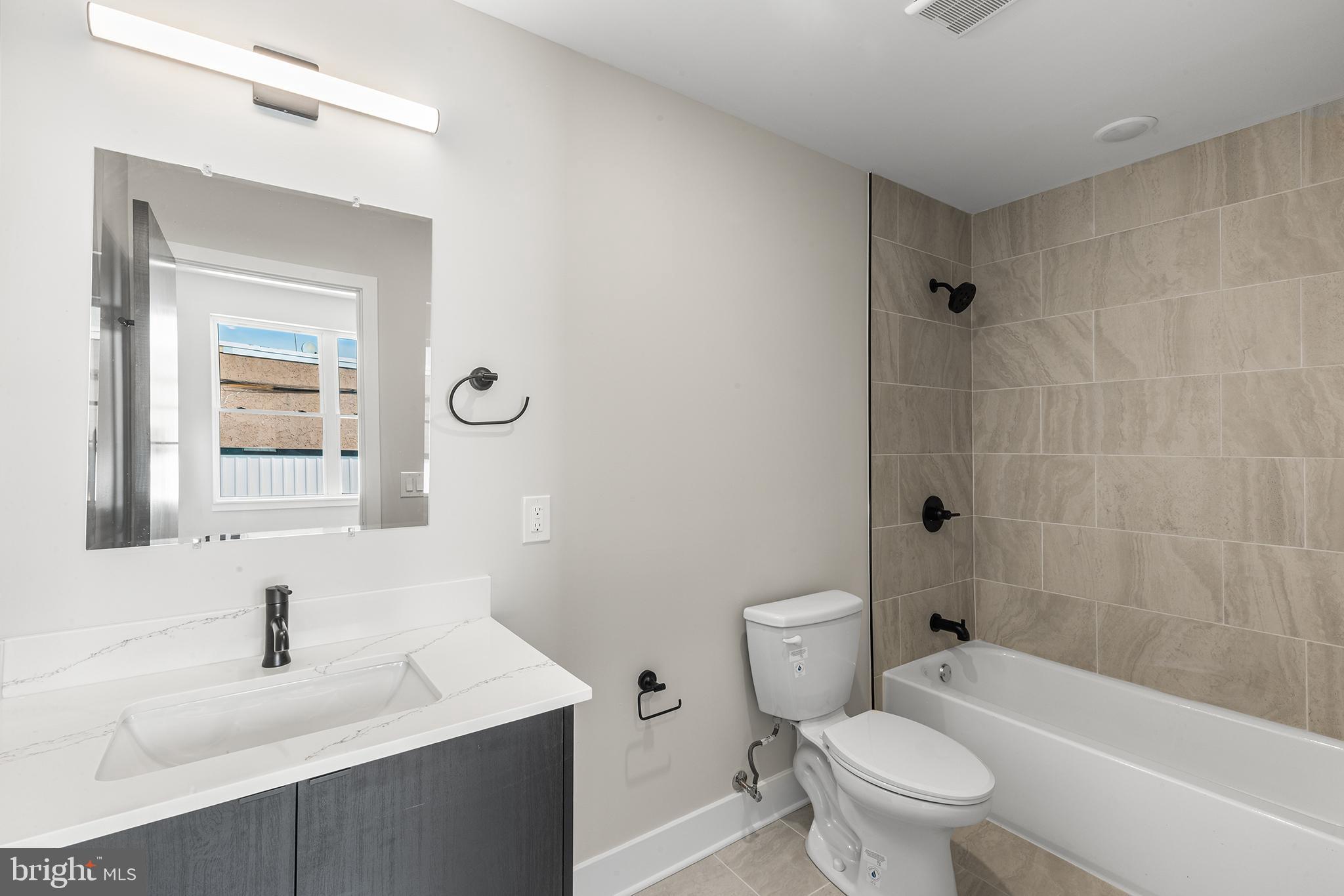 1903 Jackson Street, Unit 1 Philadelphia, PA 19145 - Photo 15 of 17 a bathroom with a sink a toilet and shower