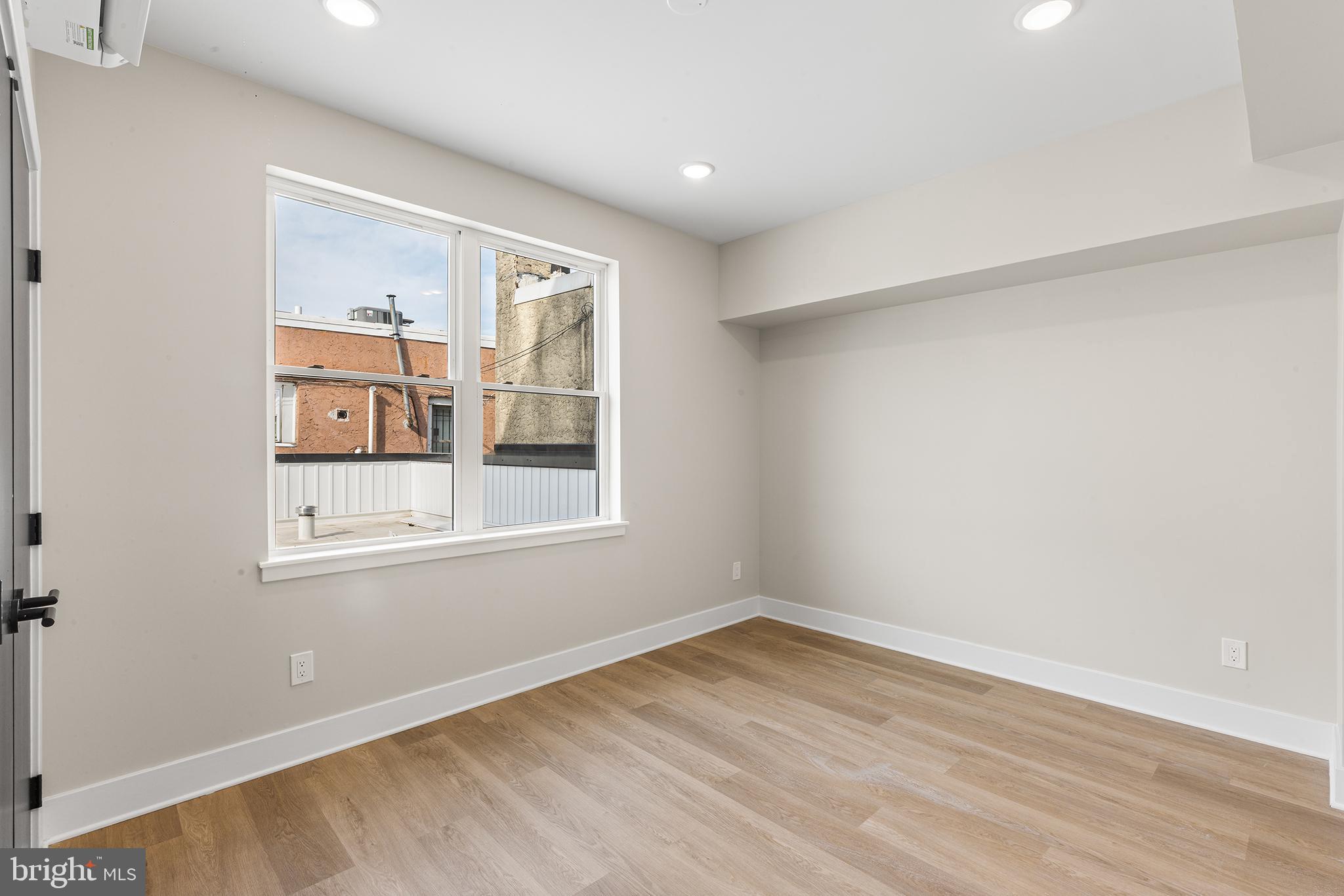 1903 Jackson Street, Unit 1 Philadelphia, PA 19145 - Photo 8 of 17 a view of empty room with wooden floor and fan