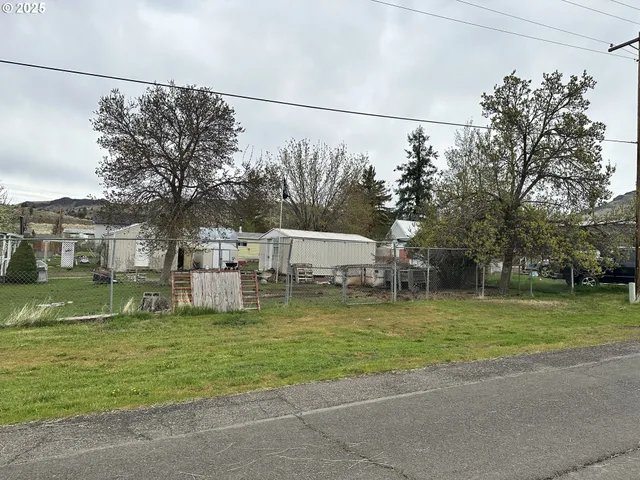 a white house that has a tree in front of it