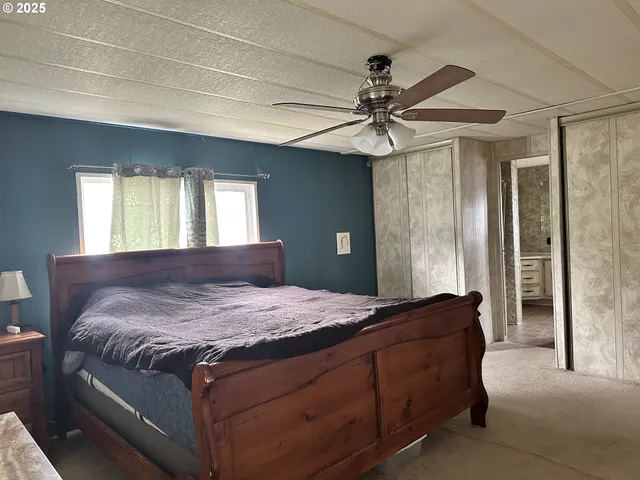 a bedroom with a large bed and a chandelier