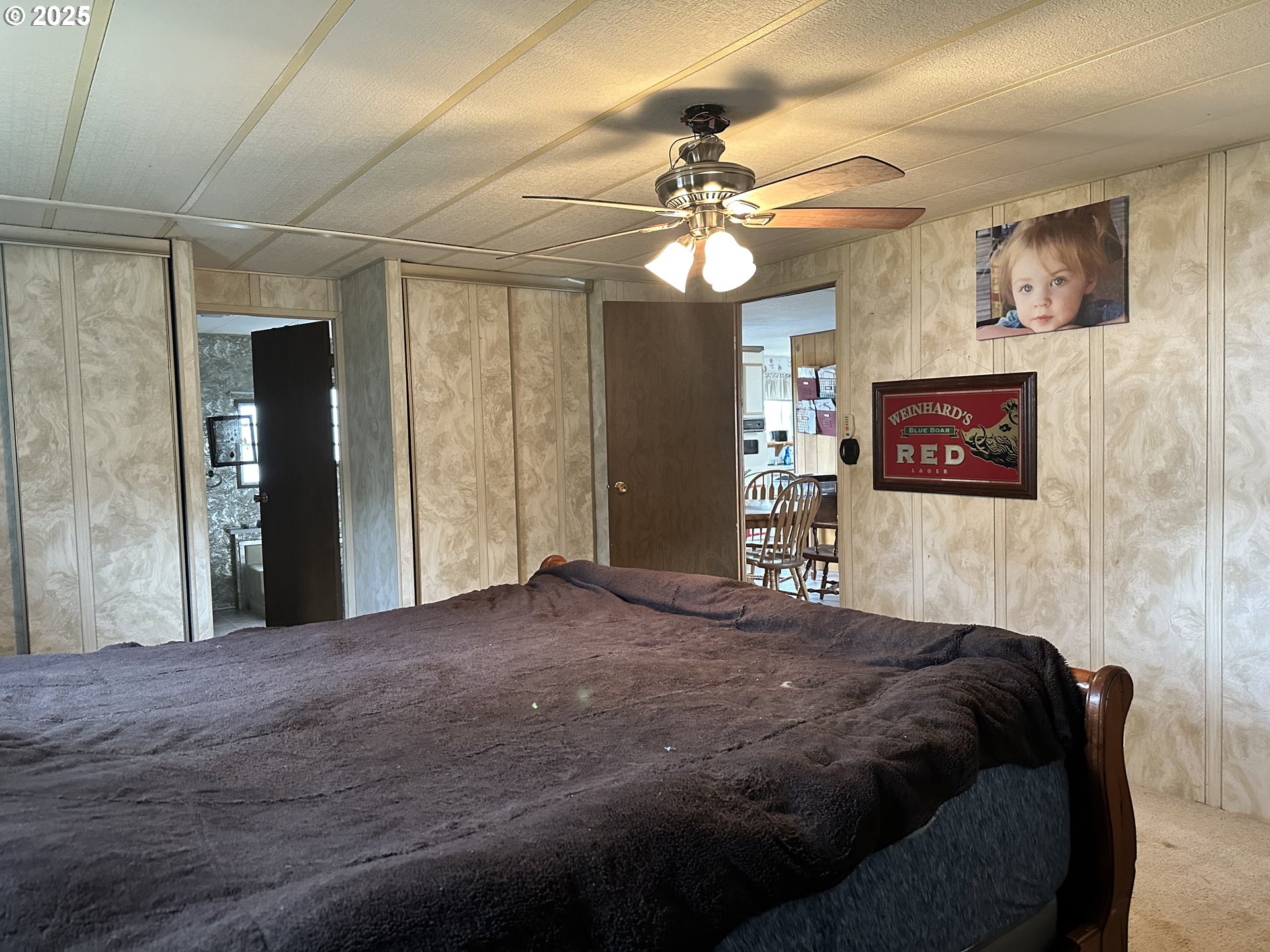 1015 C Street Fossil, OR 97830 - Photo 28 of 33 a bedroom with a large bed and a chandelier