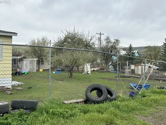 a view of a wooden deck and a yard