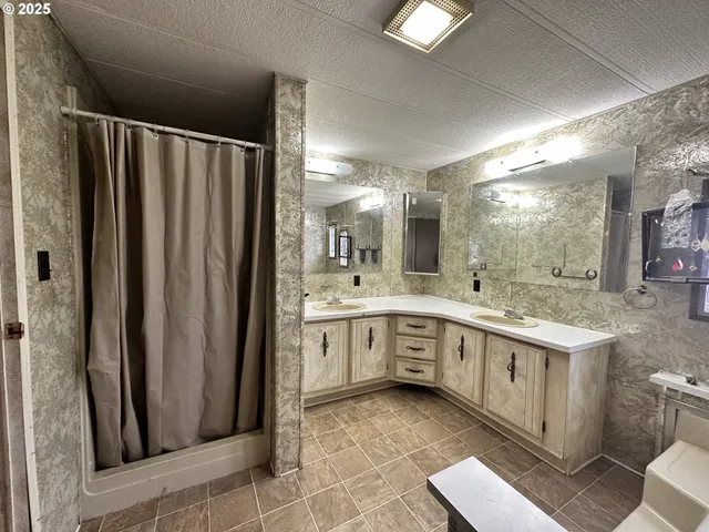 a large bathroom with a double vanity sink and a mirror