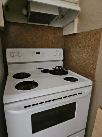a stove top oven sitting inside of a kitchen