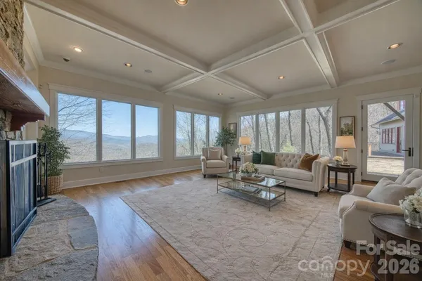 a view of a room that has a window and wooden floor