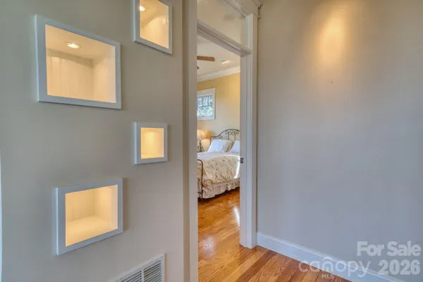 a bedroom with a bed and a lamp on the dresser