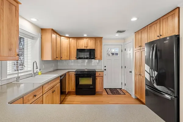 a kitchen with a refrigerator stove and sink