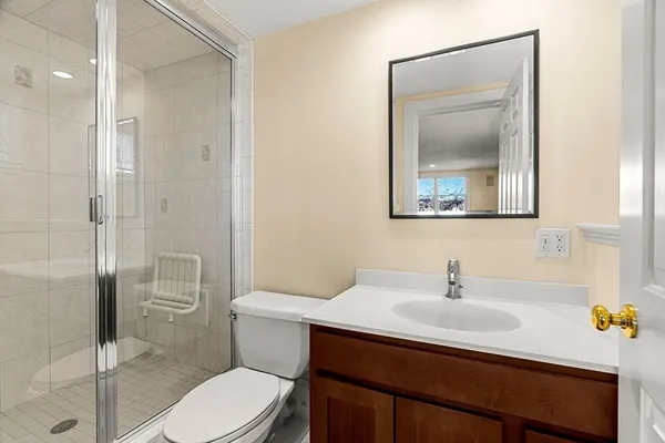 a bathroom with a sink a toilet and shower