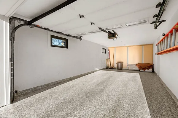 an empty room with windows and ceiling fan