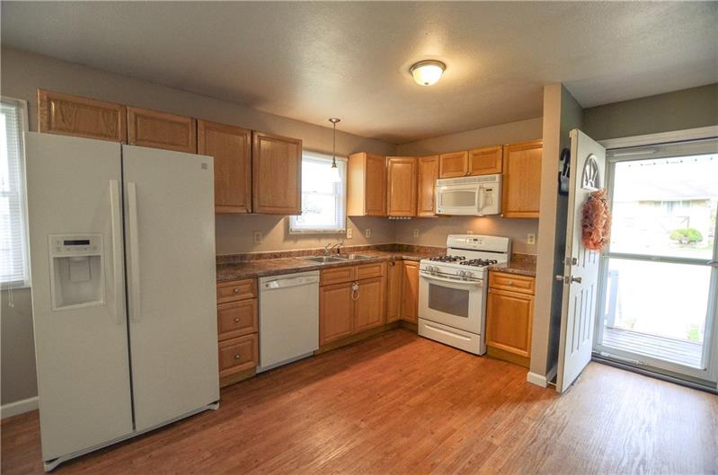 2090 Marshall Road Monaca, PA 15061 - Photo 8 of 24 Beautiful wood cabinets, over-the-sink window, and counter space are great features of the kitchen.
