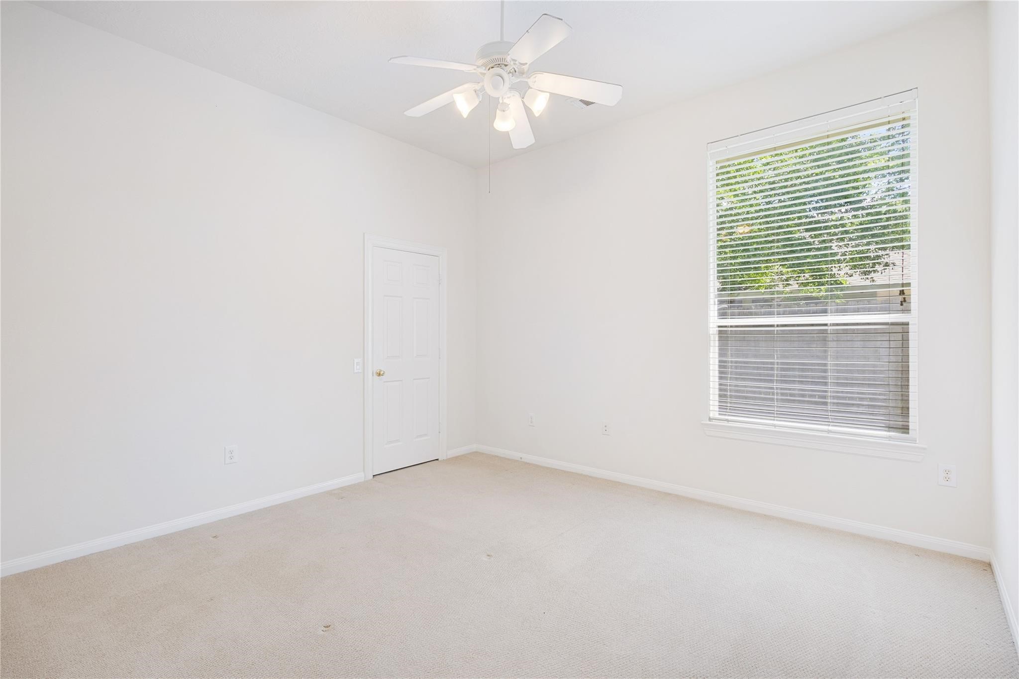 43 Tarrytown Way Conroe, TX 77384 - Photo 28 of 40 an empty room with a window and a fan