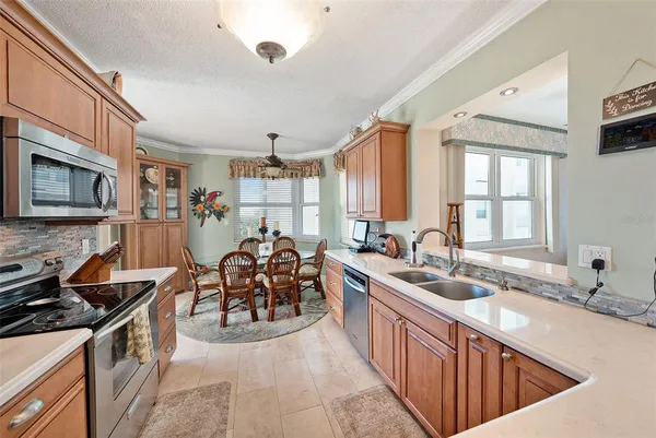a large kitchen with stainless steel appliances granite countertop a sink and a stove