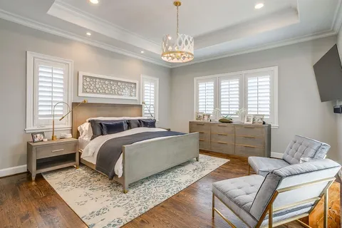 a spacious bathroom with a granite countertop sink a large mirror and a shower