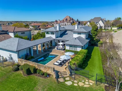 an aerial view of a house with a big yard