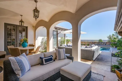 a dining room with furniture a fireplace and a chandelier