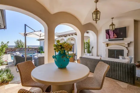 a view of a house with backyard porch and sitting area