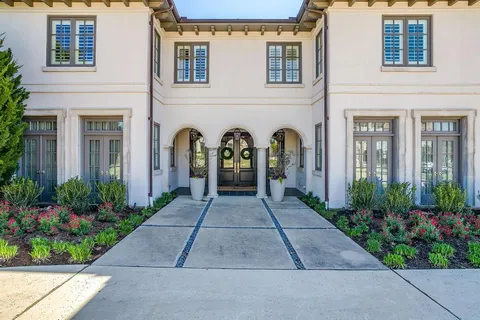 front view of house with potted plants