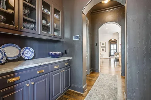 a living room with furniture fireplace and a chandelier