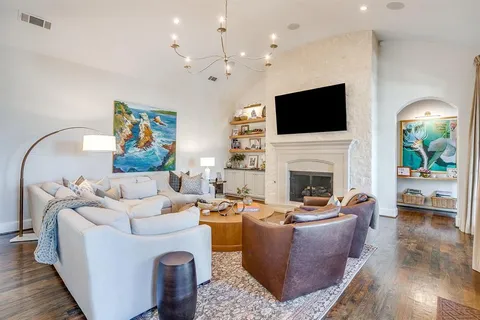 a dining room with stainless steel appliances kitchen island granite countertop a dining table and chairs with wooden floor