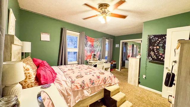 a bedroom with a bed dresser and a window